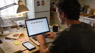 Blogger reviewing an on-page SEO checklist on a laptop before publishing a post