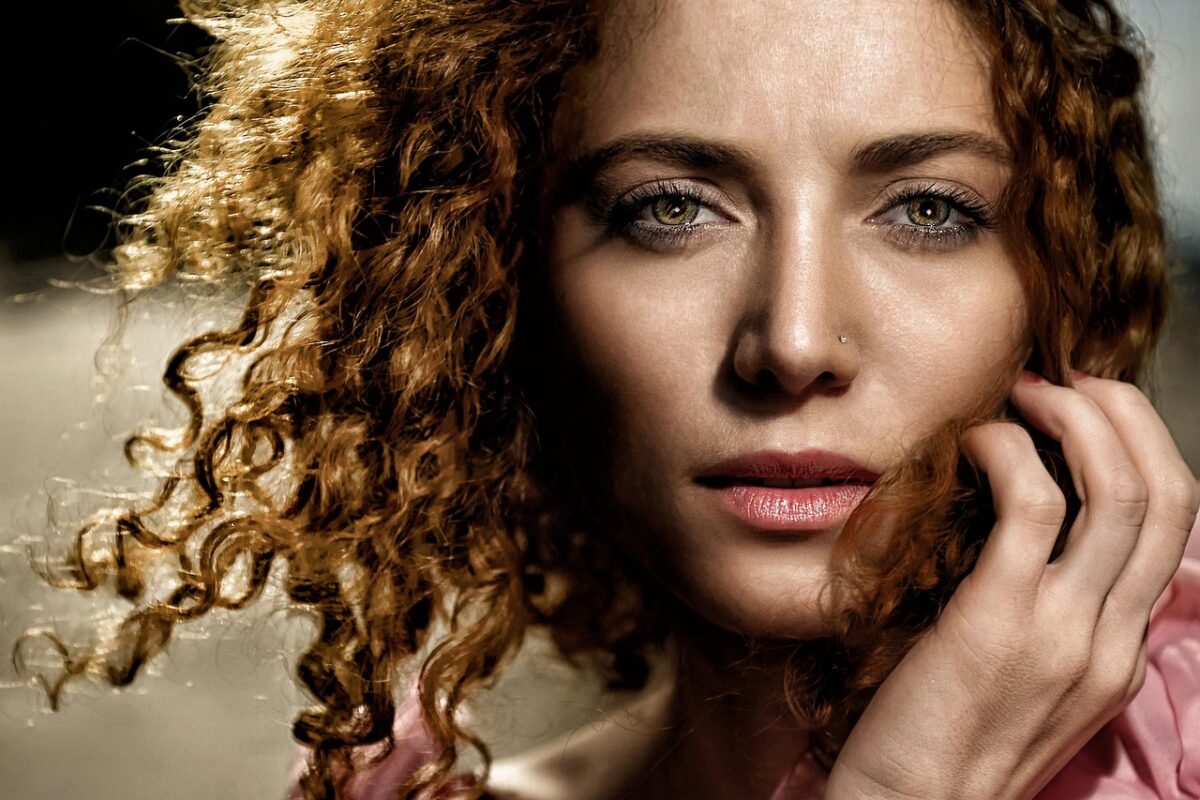 a close‑up of a woman’s glossy, moisturized hair after applying oil