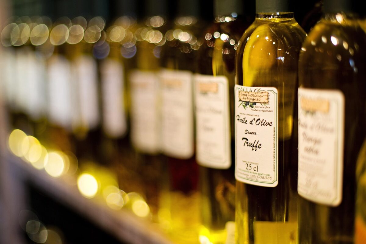 a collection of small bottles of various natural hair oils arranged on a marble countertop