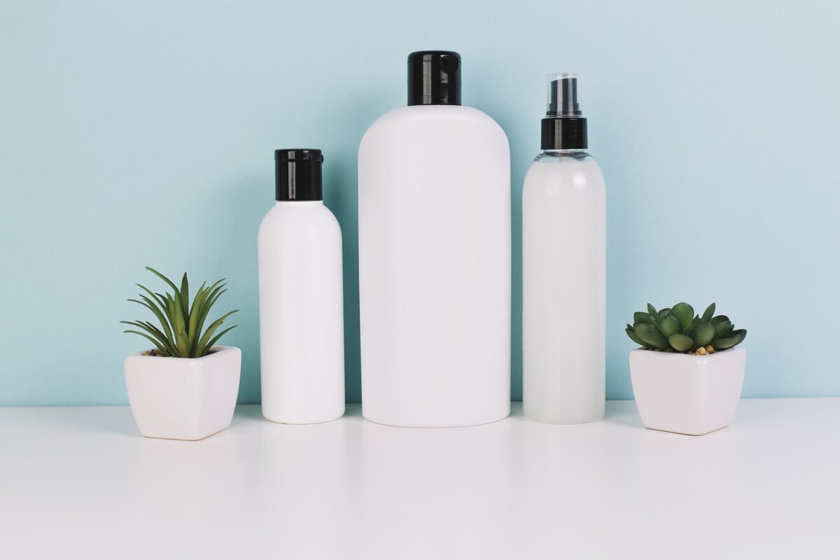 a neatly arranged countertop featuring a cleanser, toner, moisturizer, and sunscreen bottle